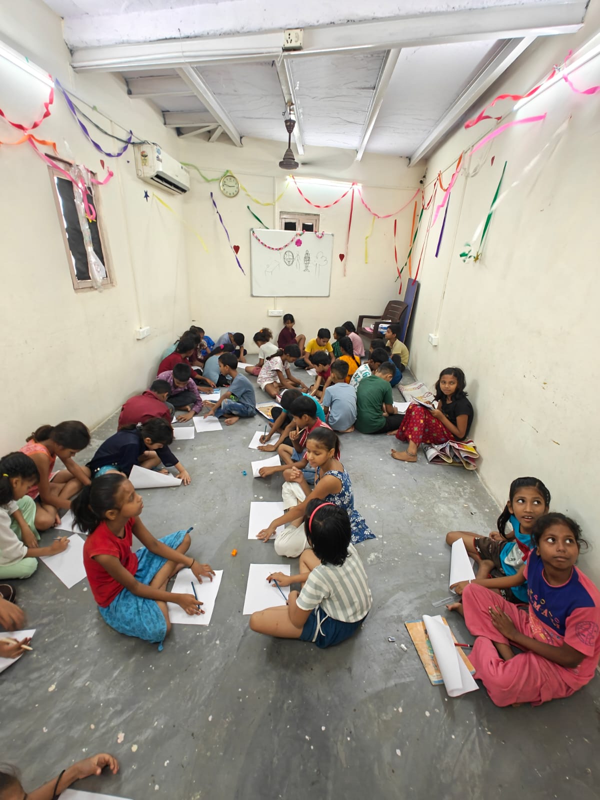 Children drawing in the Sanjay Colony workshop